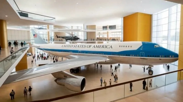 Air Force One exhibit in a museum with visitors walking around, showcasing the presidential aircraft's interior and design