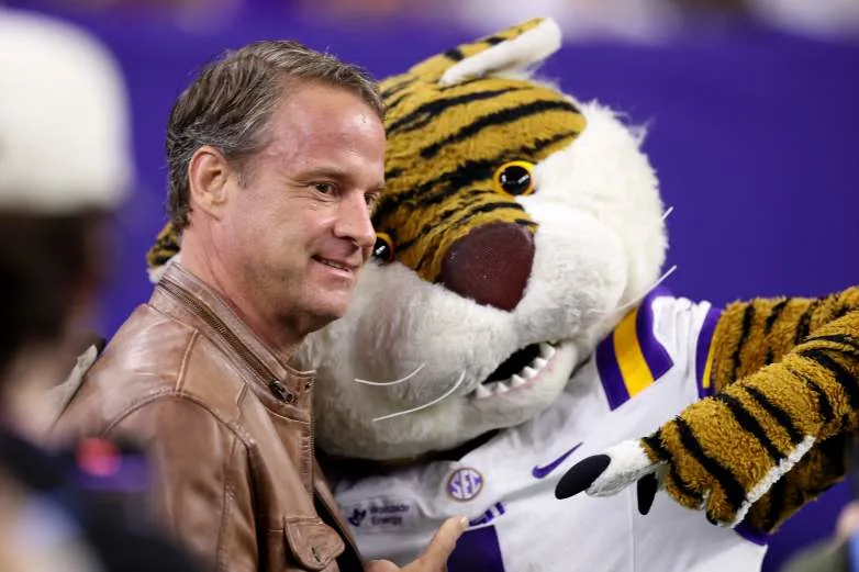 HOUSTON, TEXAS - DECEMBER 27: Head coach Lane Kiffin of the Louisiana State Tigers poses with the mascot before the game against the Houston Cougars during the Kinder's Texas Bowl at NRG Stadium on December 27, 2025 in Houston, Texas. (Photo by Tim Warner/Getty Images)