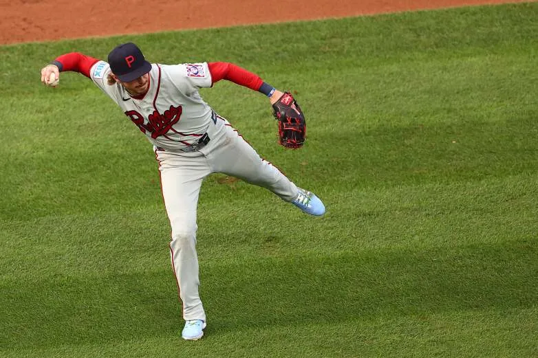 DYERSVILLE, IOWA - AUGUST 13: Bryson Stott #5 of the Philadelphia Phillies throws during the third inning against the Minnesota Twins] at Field of Dreams on August 13, 2026 in Dyersville, Iowa. (Photo by Tyler Clouse/Getty Images)