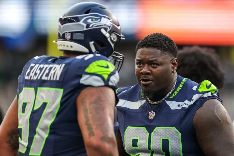 SEATTLE, WASHINGTON - AUGUST 15: Jarran Reed #90 of the Seattle Seahawks talks with Deven Eastern #97 during the third quarter during the NFL preseason game against the Dallas Cowboys at Lumen Field on August 15, 2026 in Seattle, Washington. (Photo by Jack Compton/Getty Images)
