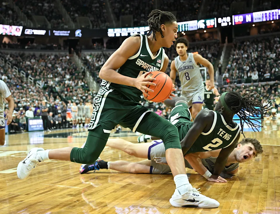 Michigan State University's Jordan Scott dribbles around teammate Kur Teng and Northwestern'sNick Martinelli who crashed into one another in the second half at the Breslin Center in East Lansing, Michigan on January 8, 2026.