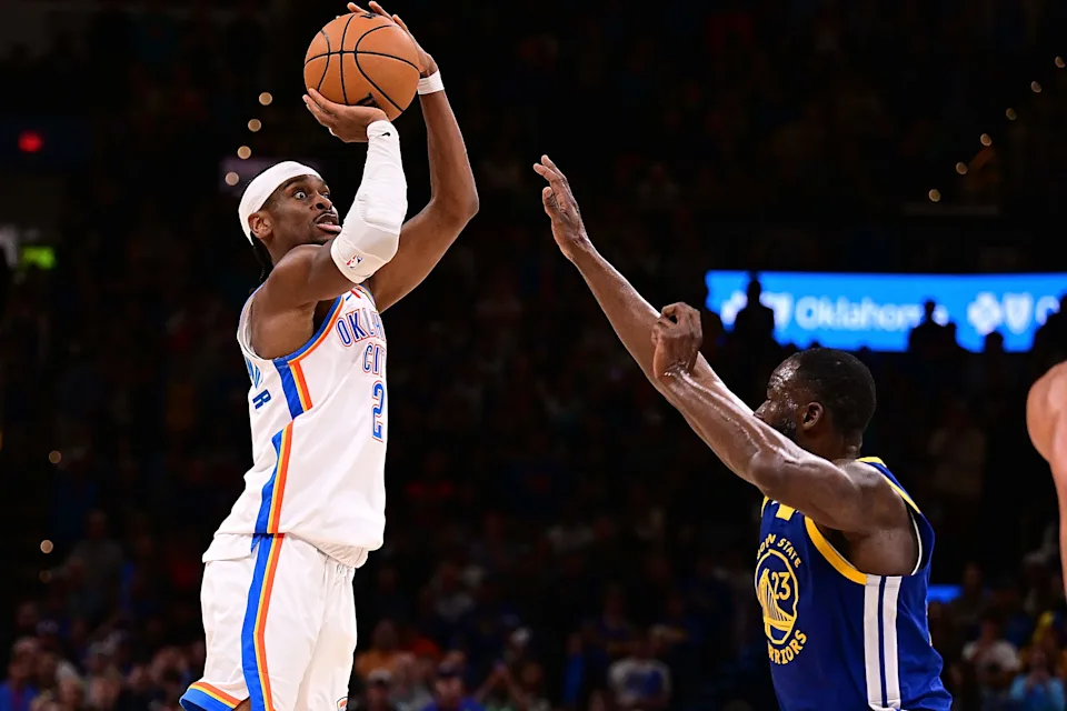 OKLAHOMA CITY, OKLAHOMA - MARCH 7: Shai Gilgeous-Alexander #2 of the Oklahoma City Thunder attempts a shot in front of Draymond Green #23 of the Golden State Warriors during the second half at Paycom Center on March 7, 2026 in Oklahoma City, Oklahoma. NOTE TO USER: User expressly acknowledges and agrees that, by downloading and or using this photograph, User is consenting to the terms and conditions of the Getty Images License Agreement. (Photo by Joshua Gateley/Getty Images)