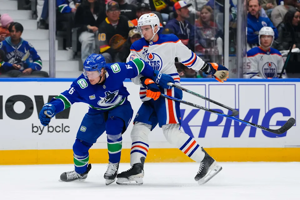 VANCOUVER, CANADA - OCTOBER 1: Brock Boeser #6 of the Vancouver Canucks is held up by Ryan Shea #6 of the Edmonton Oilers during the first period of their NHL game at Rogers Arena on October 1, 2026 in Vancouver, British Columbia, Canada. (Photo by Derek Cain/Getty Images)