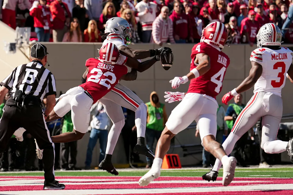 Ohio State Buckeyes wide receiver Jeremiah Smith (4) catches a touchdown while being defended by Indiana Hoosiers defensive back Jamari Sharpe (22) during the NCAA football game at Memorial Stadium Stadium in Bloomington, Ind. on Oct. 17, 2026.